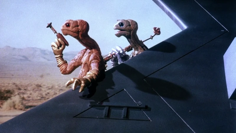 They wave at the camera. They wave at the camera.